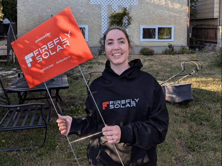 Happy Firefly Solar customer with team member