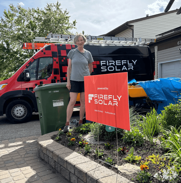 Customer next to Firefly Solar van and installation