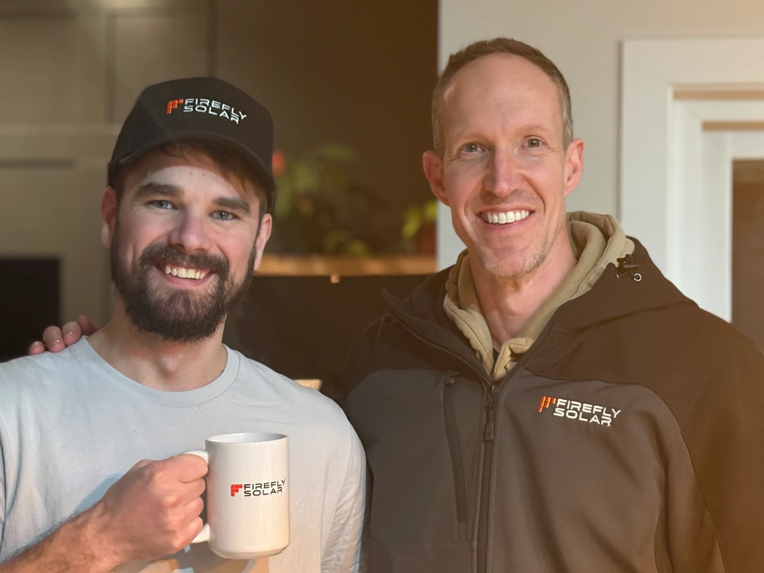 Customer and Firefly Solar team member with mug